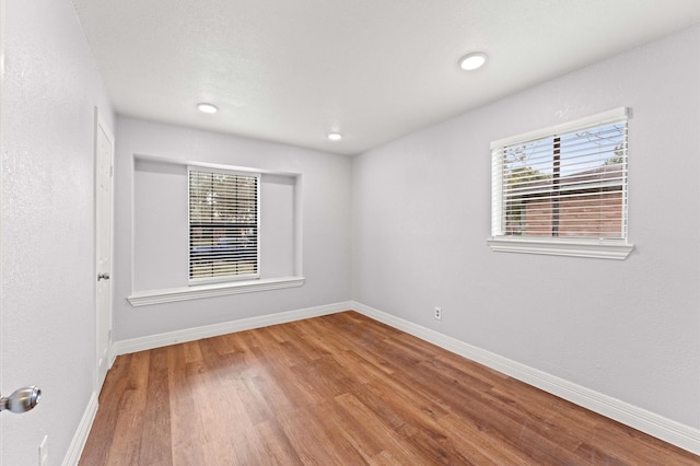6105 Arthington St, Houston, TX 77053 - spare room with wood finished floors, baseboards, plenty of natural light, and recessed lighting