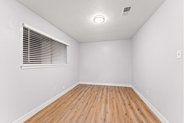 6105 Arthington St, Houston, TX 77053 - unfurnished room featuring light wood-style floors, baseboards, and a textured ceiling
