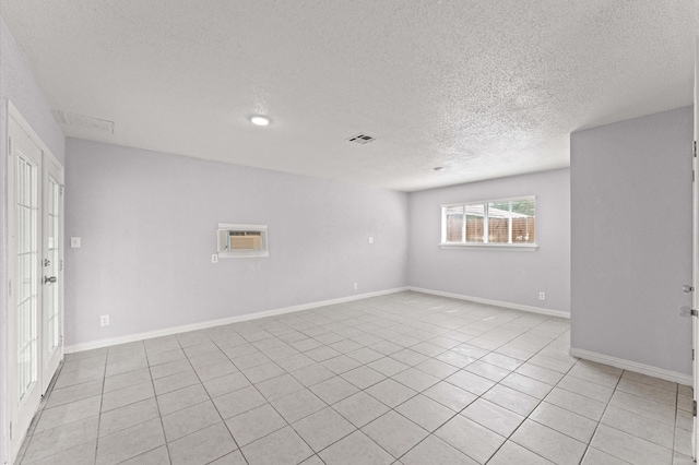 6105 Arthington St, Houston, TX 77053 - spare room with a textured ceiling, light tile patterned floors, a wall mounted air conditioner, and baseboards