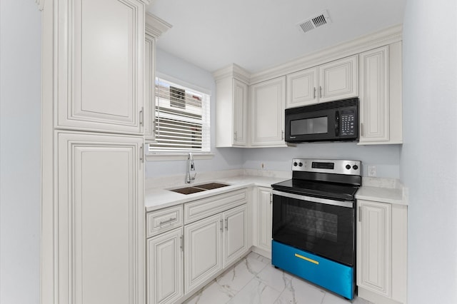 6105 Arthington St, Houston, TX 77053 - kitchen with black microwave, electric range, a sink, light marble finish floors, and light countertops