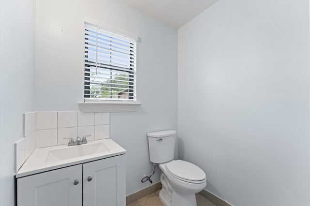 6105 Arthington St, Houston, TX 77053 - half bath with toilet, vanity, backsplash, tile patterned flooring, and baseboards