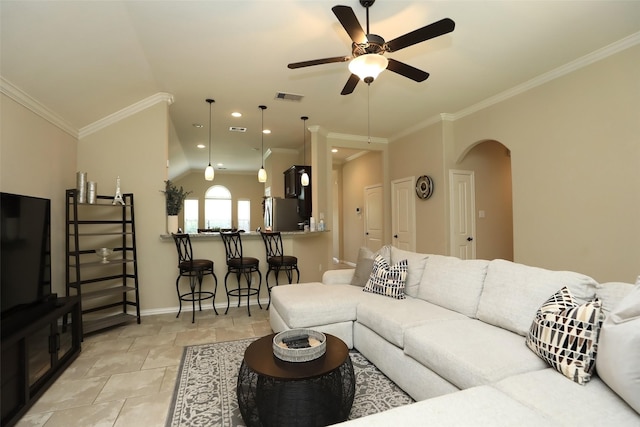 living area with arched walkways, ceiling fan, ornamental molding, baseboards, and lofted ceiling