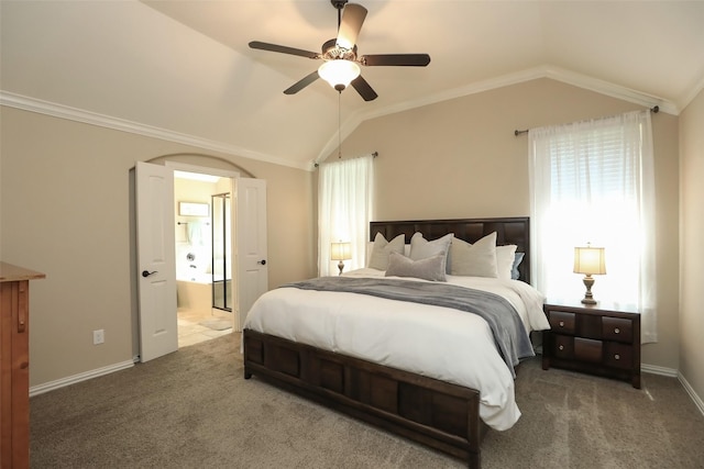 bedroom featuring lofted ceiling, carpet flooring, arched walkways, connected bathroom, and ceiling fan
