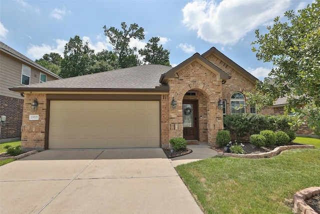 view of front of house with brick siding, an attached garage, concrete driveway, a front lawn, and a shingled roof