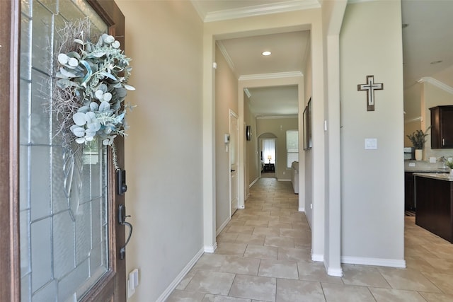 foyer with baseboards, ornamental molding, light tile patterned floors, and recessed lighting