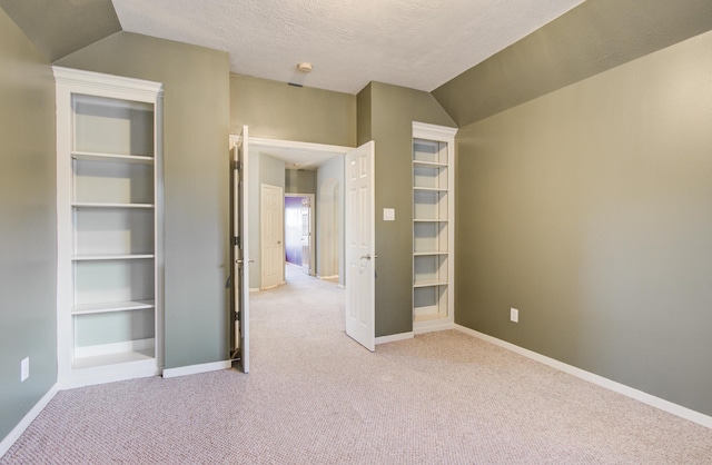 10711 Sea Myrtle Dr, Houston, TX 77095 - unfurnished bedroom featuring light colored carpet, baseboards, and lofted ceiling