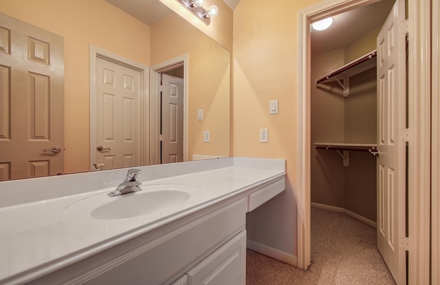 10711 Sea Myrtle Dr, Houston, TX 77095 - bathroom with vanity, baseboards, and a spacious closet
