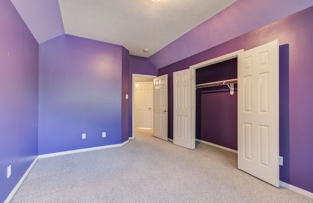 10711 Sea Myrtle Dr, Houston, TX 77095 - unfurnished bedroom with carpet floors, vaulted ceiling, baseboards, and a closet