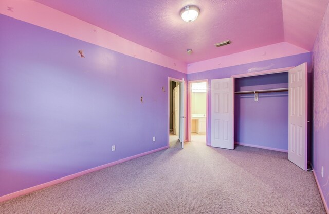 10711 Sea Myrtle Dr, Houston, TX 77095 - unfurnished bedroom featuring carpet flooring, a closet, baseboards, and a textured ceiling