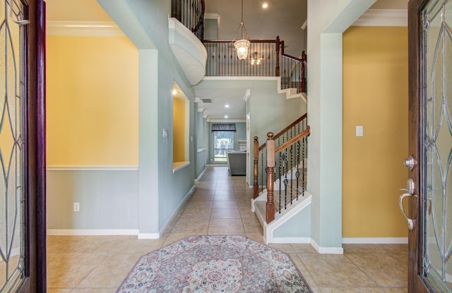 10711 Sea Myrtle Dr, Houston, TX 77095 - tiled entrance foyer with crown molding, stairs, a chandelier, baseboards, and a high ceiling