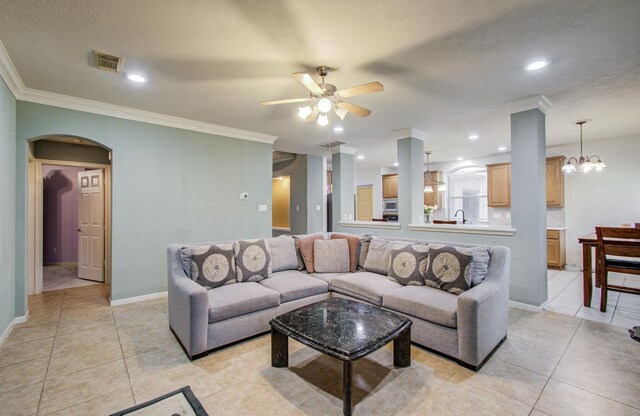 10711 Sea Myrtle Dr, Houston, TX 77095 - living room with ornamental molding, a ceiling fan, arched walkways, light tile patterned floors, and baseboards