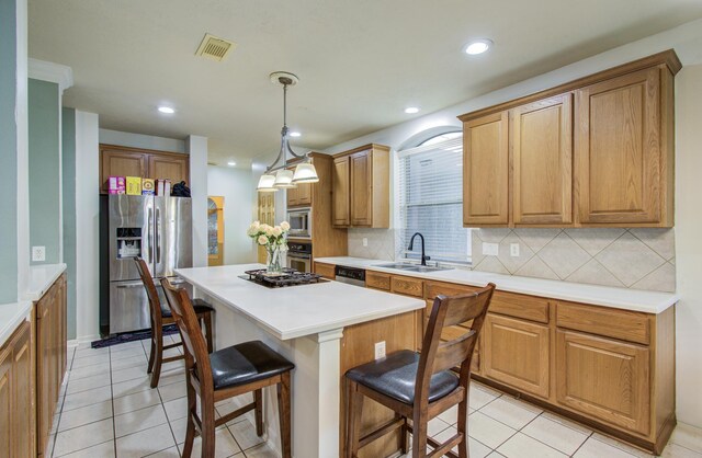 10711 Sea Myrtle Dr, Houston, TX 77095 - kitchen with appliances with stainless steel finishes, a sink, a breakfast bar, a center island, and tasteful backsplash