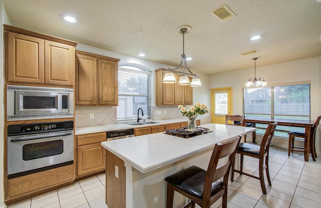 10711 Sea Myrtle Dr, Houston, TX 77095 - kitchen with stainless steel appliances, a sink, tasteful backsplash, light countertops, and light tile patterned floors