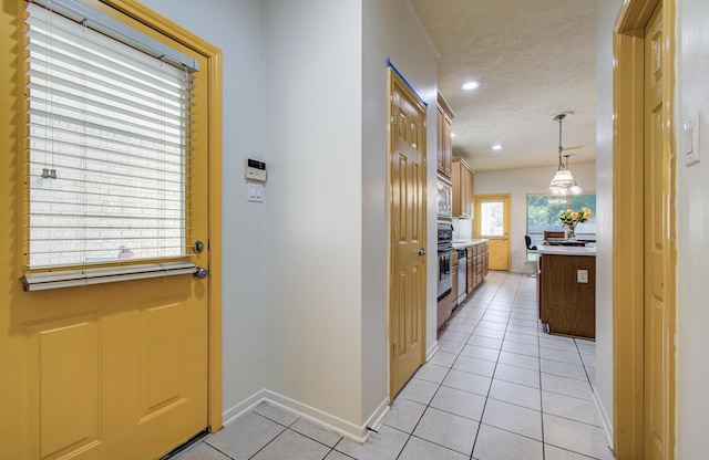 10711 Sea Myrtle Dr, Houston, TX 77095 - entryway featuring light tile patterned flooring, baseboards, and recessed lighting