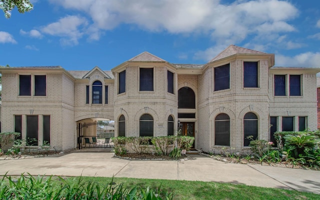 10711 Sea Myrtle Dr, Houston, TX 77095 - french country home with brick siding and a gate