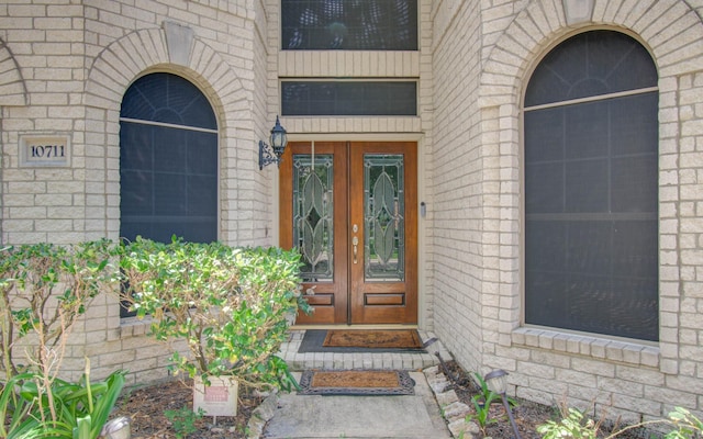 10711 Sea Myrtle Dr, Houston, TX 77095 - doorway to property with french doors, stone siding, and brick siding