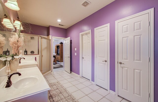 10711 Sea Myrtle Dr, Houston, TX 77095 - full bathroom with tile patterned flooring, a stall shower, double vanity, recessed lighting, and baseboards