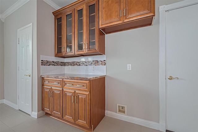 5714 Ames Xing, Sugar Land, TX 77479 - bar with crown molding, tasteful backsplash, baseboards, and light tile patterned flooring