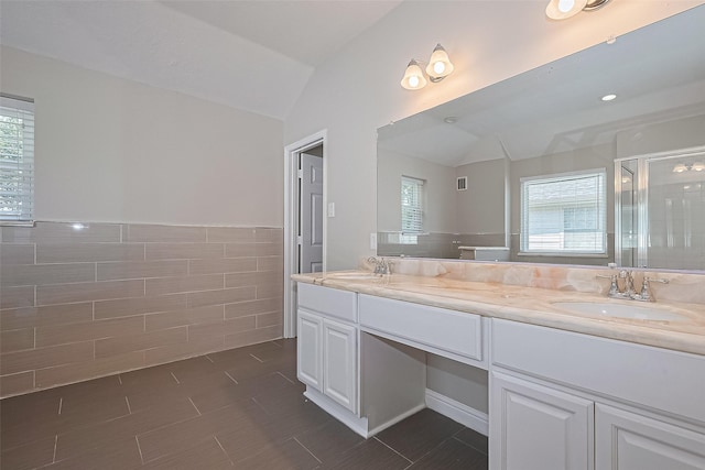 5714 Ames Xing, Sugar Land, TX 77479 - full bath with lofted ceiling, tile walls, a stall shower, healthy amount of natural light, and double vanity