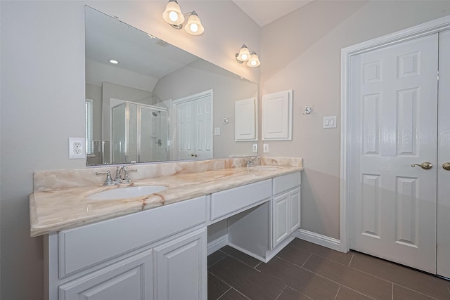 5714 Ames Xing, Sugar Land, TX 77479 - bathroom featuring a shower stall, double vanity, baseboards, and wood finish floors