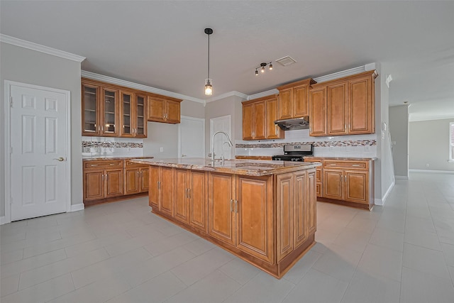 5714 Ames Xing, Sugar Land, TX 77479 - kitchen featuring under cabinet range hood, brown cabinetry, stainless steel stove, decorative backsplash, and a sink