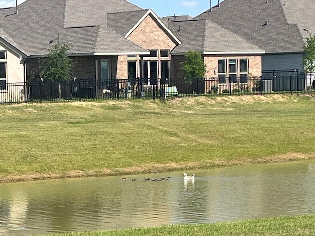 2443 Solaris Bend Dr, Katy, TX 77493 - rear view of house with roof with shingles and a water view