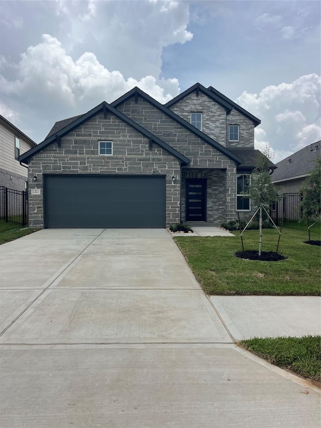 2443 Solaris Bend Dr, Katy, TX 77493 - view of front facade featuring concrete driveway, an attached garage, and stone siding