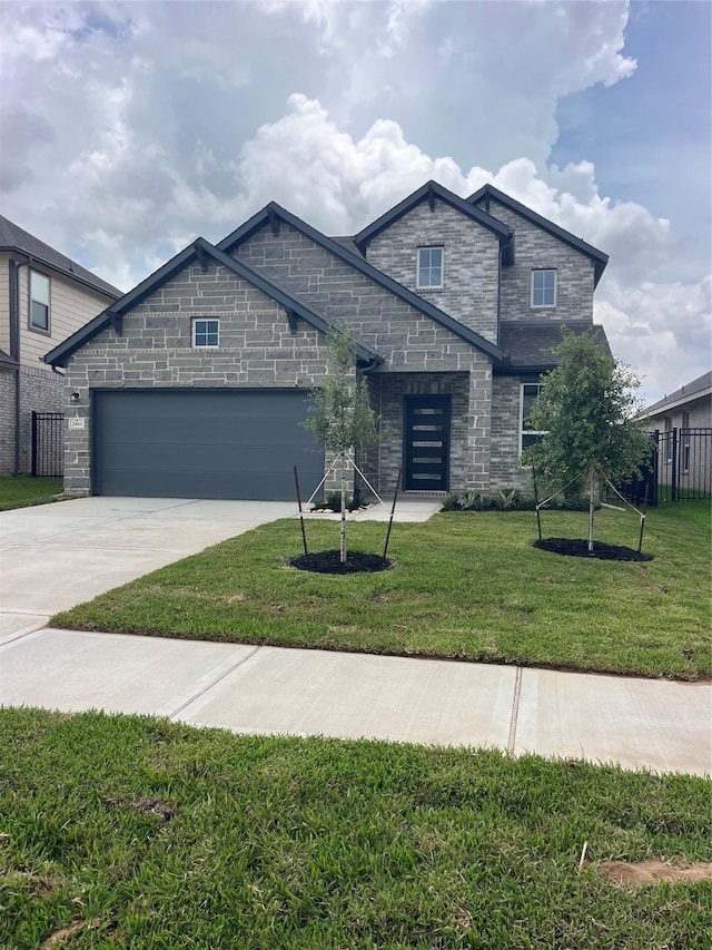 2443 Solaris Bend Dr, Katy, TX 77493 - view of front of house with an attached garage, stone siding, and concrete driveway