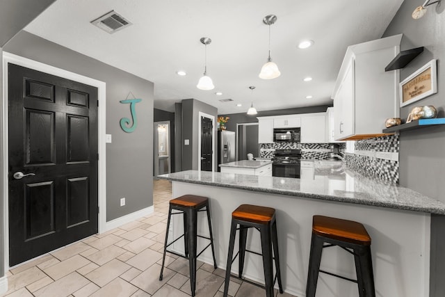 32123 Willow Creek Park, Conroe, TX 77385 - kitchen featuring black appliances, a peninsula, tasteful backsplash, white cabinets, and pendant lighting
