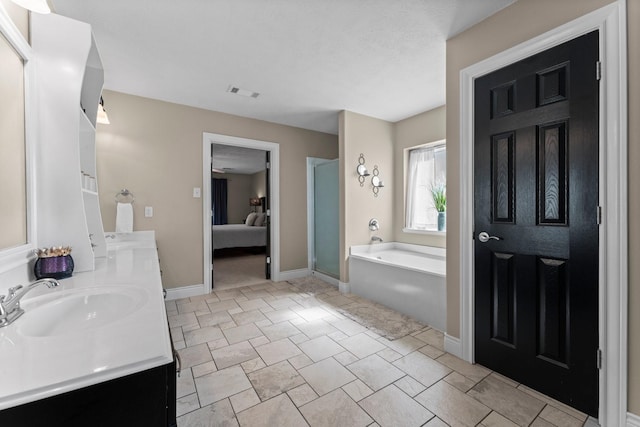 32123 Willow Creek Park, Conroe, TX 77385 - bathroom featuring connected bathroom, a garden tub, baseboards, a stall shower, and double vanity