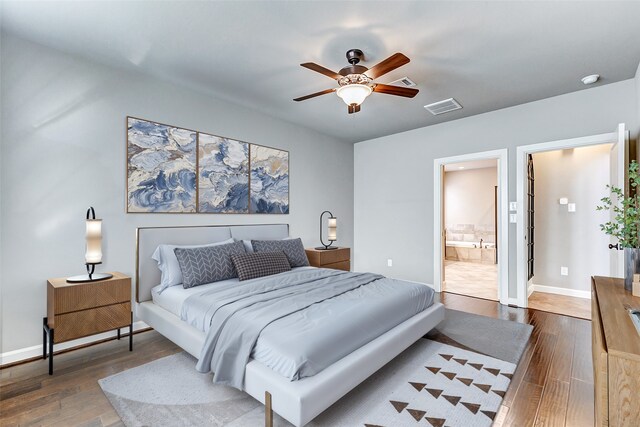 6222 Deer Run Xing, Katy, TX 77493 - bedroom with hardwood / wood-style floors, baseboards, connected bathroom, and ceiling fan