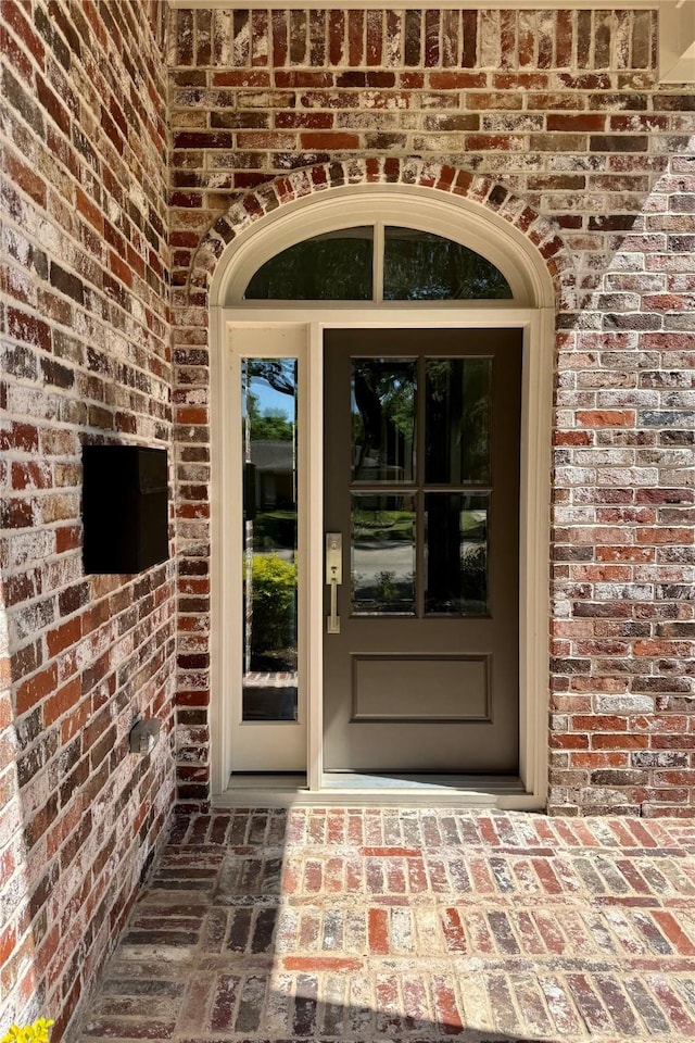 property entrance with brick siding