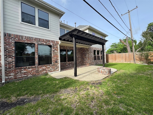 back of property with brick siding, a pergola, and a patio