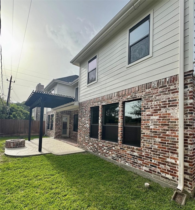 back of house with a fire pit, a patio, brick siding, and a pergola