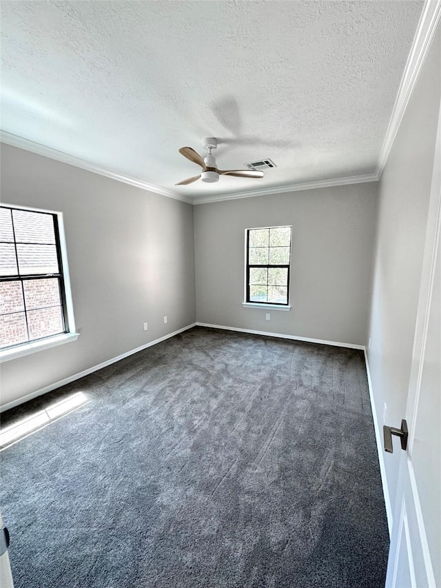 carpeted spare room with ceiling fan, crown molding, baseboards, and a textured ceiling