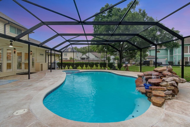 2616 Ryder Ct, League City, TX 77573 - pool at dusk with a patio area, a pool with connected hot tub, ceiling fan, and glass enclosure