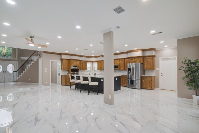 2616 Ryder Ct, League City, TX 77573 - kitchen with stainless steel appliances, brown cabinetry, ornamental molding, a breakfast bar area, and light countertops