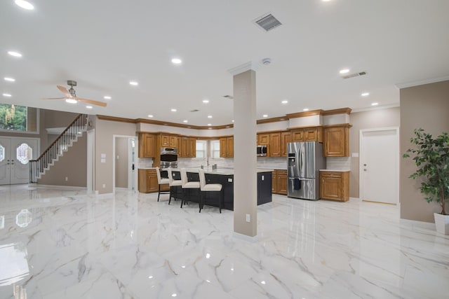 2616 Ryder Ct, League City, TX 77573 - kitchen with stainless steel appliances, ornamental molding, brown cabinetry, a kitchen breakfast bar, and healthy amount of natural light