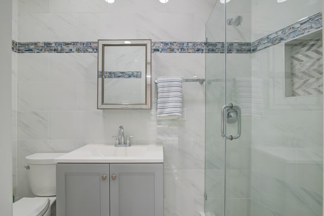 2616 Ryder Ct, League City, TX 77573 - full bathroom with toilet, vanity, a shower stall, and tile walls