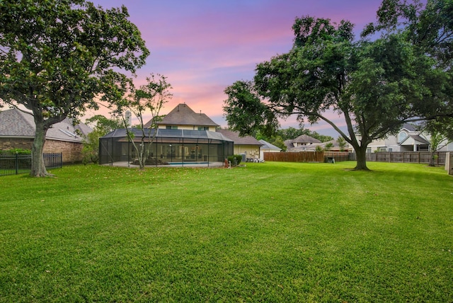 2616 Ryder Ct, League City, TX 77573 - yard at dusk featuring a fenced backyard and glass enclosure