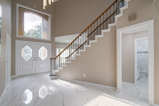 2616 Ryder Ct, League City, TX 77573 - entrance foyer featuring a towering ceiling, marble tiled flooring, stairway, and baseboards