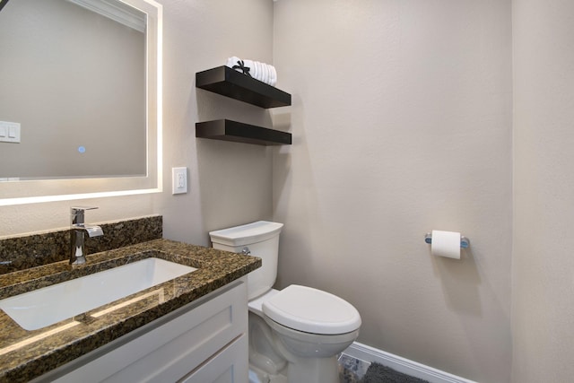 2616 Ryder Ct, League City, TX 77573 - bathroom with toilet, vanity, and baseboards
