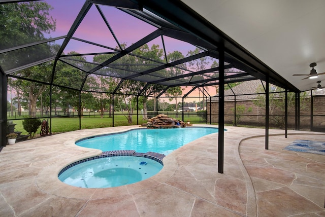 2616 Ryder Ct, League City, TX 77573 - pool at dusk with a pool with connected hot tub, a patio area, a ceiling fan, and a lanai