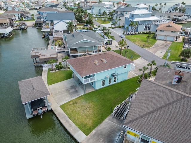 1322 Oahu Dr, Tiki Island, TX 77554 - aerial perspective of suburban area featuring a nearby body of water