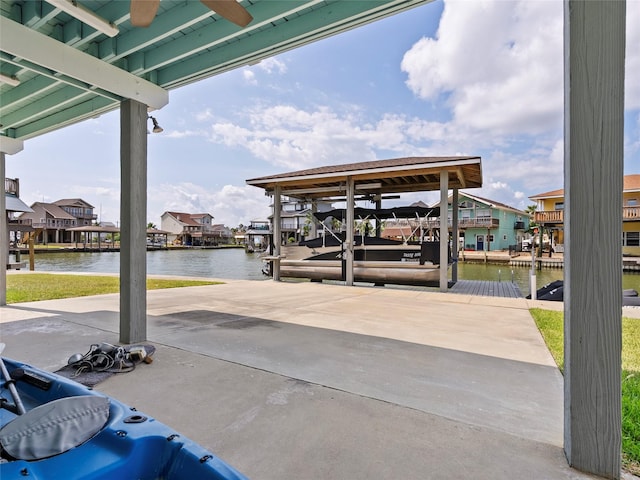 1322 Oahu Dr, Tiki Island, TX 77554 - view of patio / terrace with a dock, a water view, boat lift, and a residential view