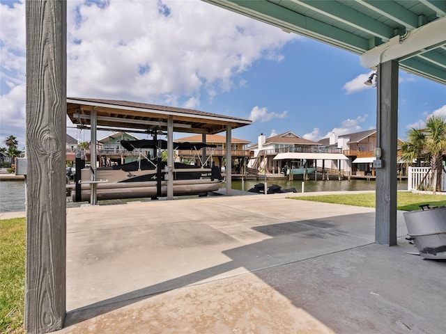 1322 Oahu Dr, Tiki Island, TX 77554 - view of patio with boat lift, a boat dock, a water view, and a residential view