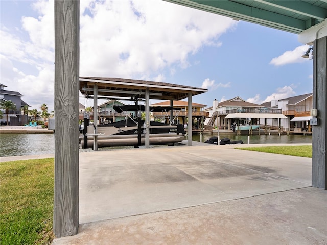 1322 Oahu Dr, Tiki Island, TX 77554 - view of parking featuring boat lift, a dock, a water view, and a residential view