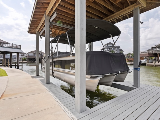 1322 Oahu Dr, Tiki Island, TX 77554 - dock area with boat lift and a water view