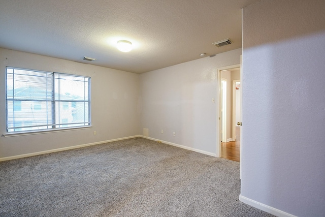 15522 Noble Brook Ct, Houston, TX 77049 - carpeted spare room featuring baseboards and a textured ceiling