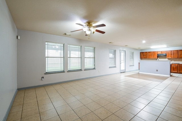 15522 Noble Brook Ct, Houston, TX 77049 - unfurnished living room with ceiling fan, light tile patterned flooring, and baseboards
